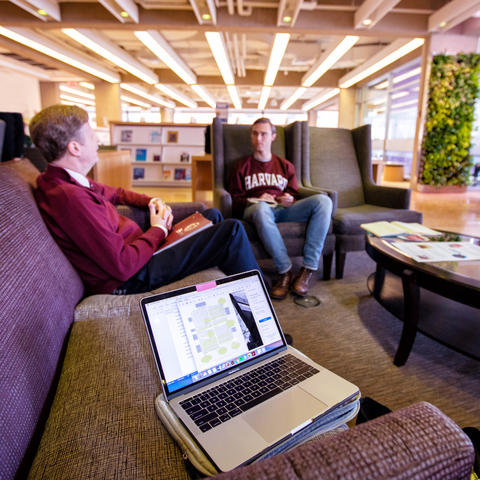 Computer screen with two people in background